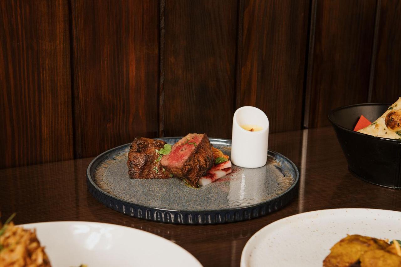 Отель The Lalit Лондон Экстерьер фото A plate of grilled lamb